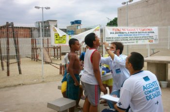 Na foto Dr. Érico Souza (Dentista da CFSVM) e o Agente Comunitário de Saúde Lauro Baptista atendendo as crianças da Comunidade do Morro da Coroa, Rio de Janeiro-RJ. 